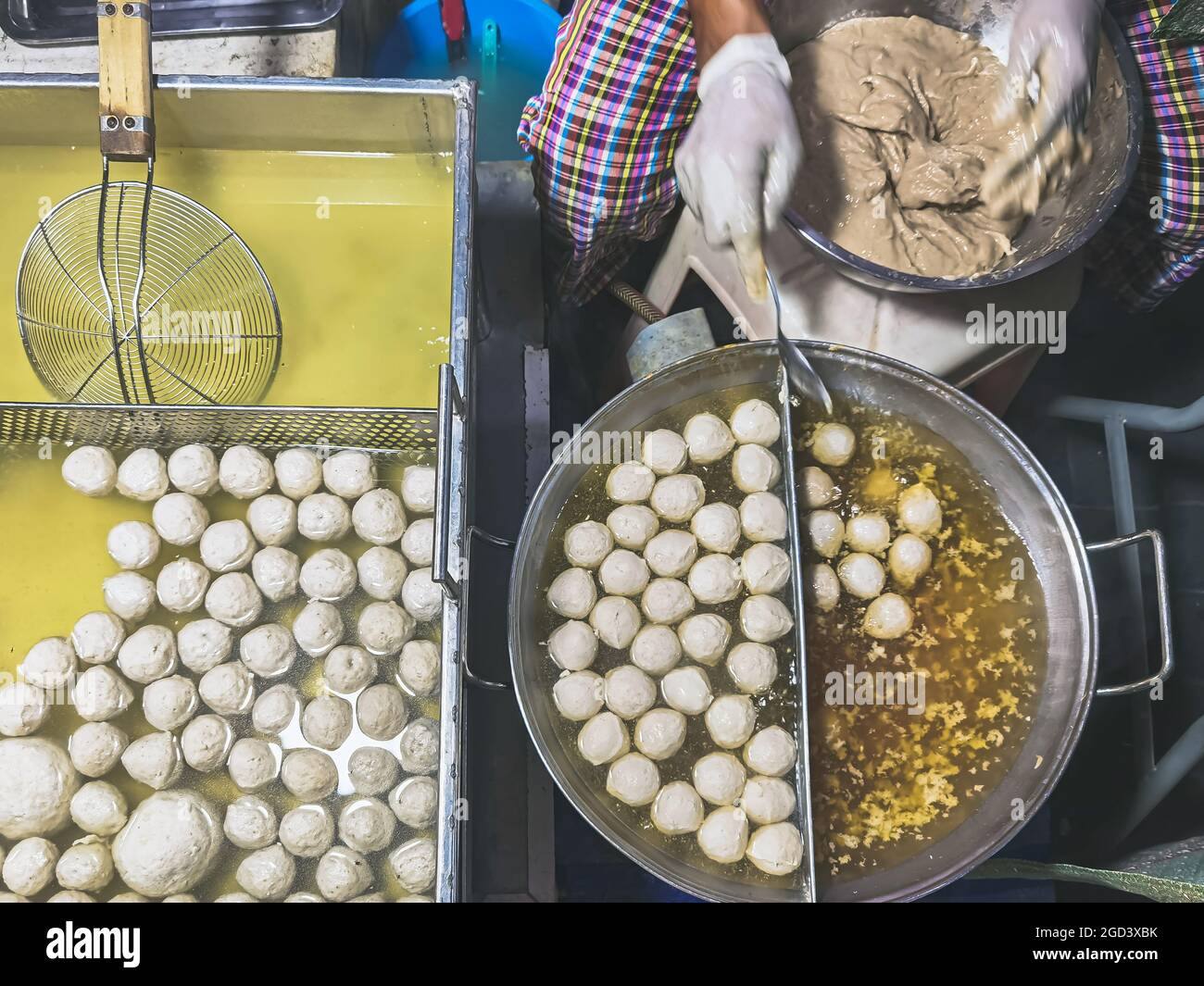 The process of making meatballs in a pan of boiling water. Homemade