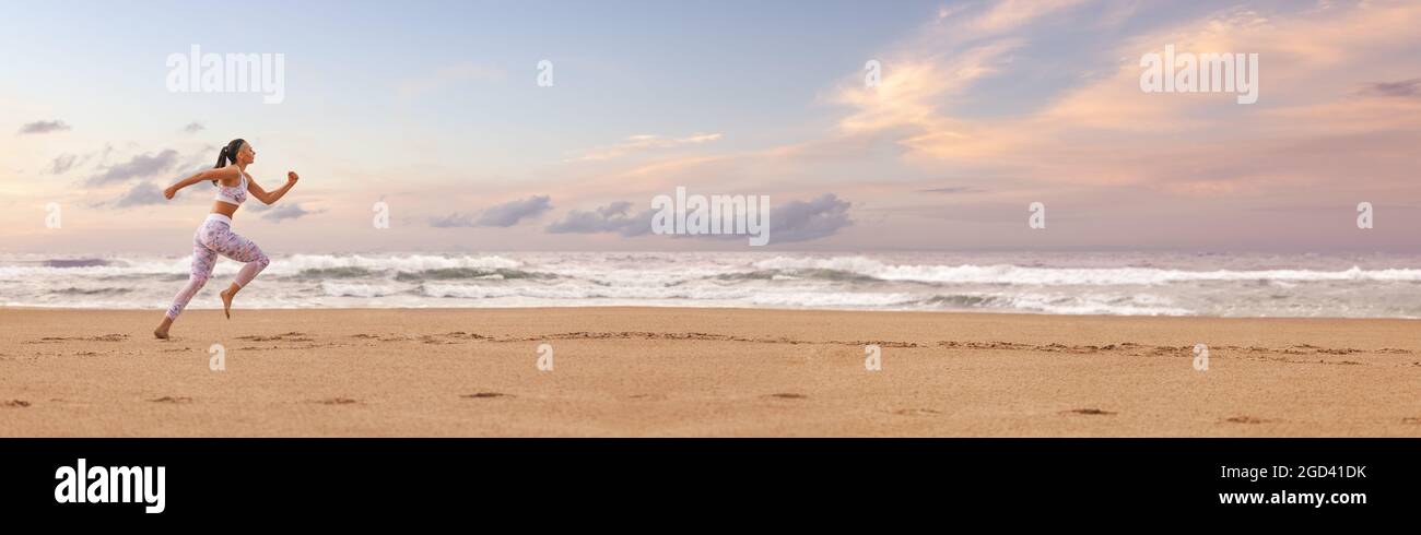 Woman running on the ocean beach during morning workout. Panoramic horizontal banner with copyspace. Stock Photo