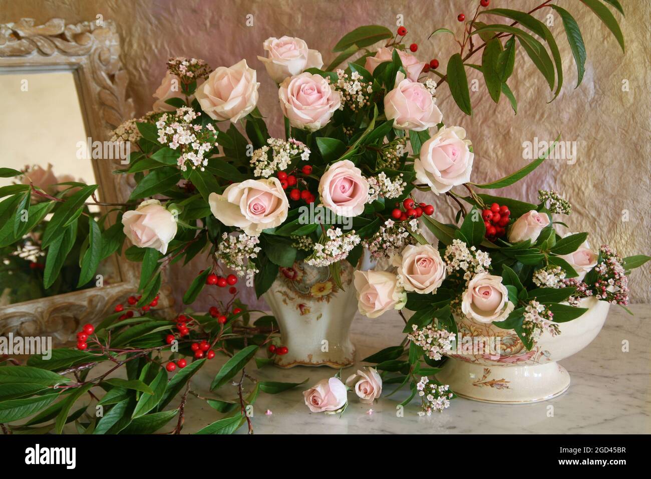 botany, pink roses, cotoneaster berries in an antique jug and bowl on a marble table., ADDITIONAL-RIGHTS-CLEARANCE-INFO-NOT-AVAILABLE Stock Photo