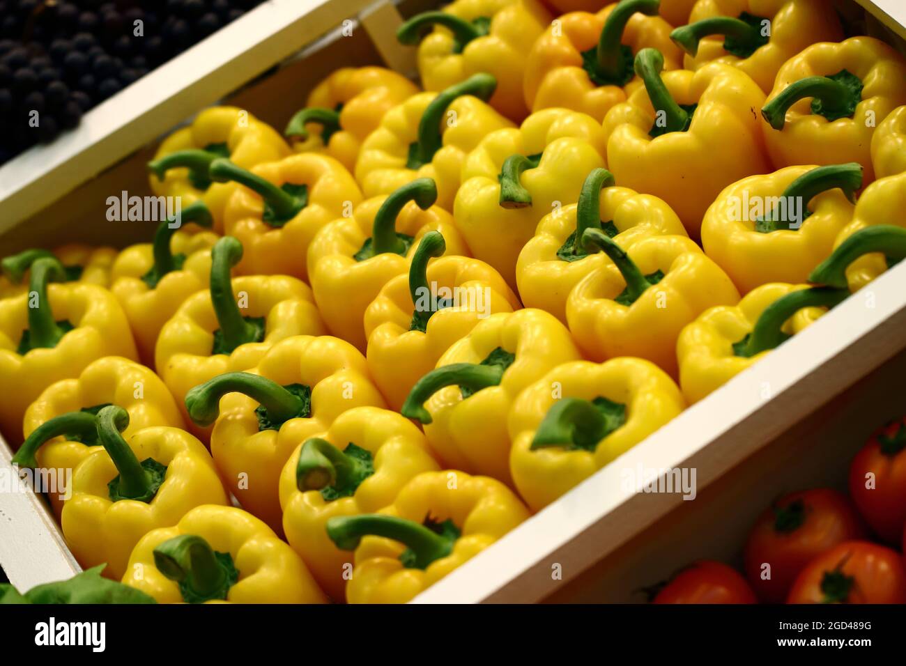 Fresh yellow sweet bell pepper in the indoor market boxes Stock Photo