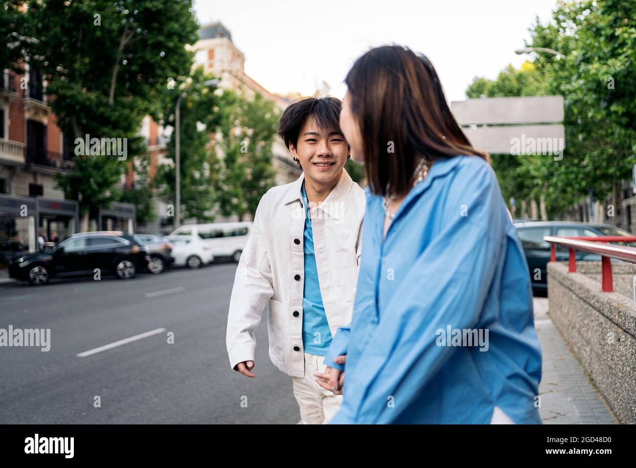 Couple holding hands crossing the street hi-res stock photography and ...