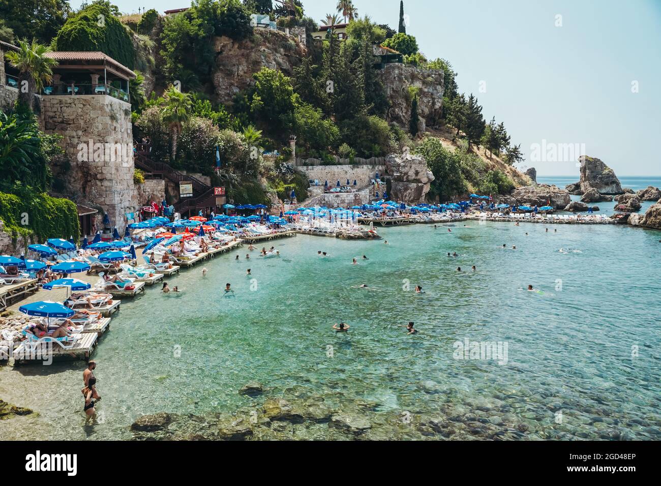 Antalya, Turkey - 30 July 2021: Mermerli beach in Antalya Turkey. Wonderful summer sunny turquoise beach on the Mediterranean coast. Rest, tourism and travel concept. . High quality photo Stock Photo