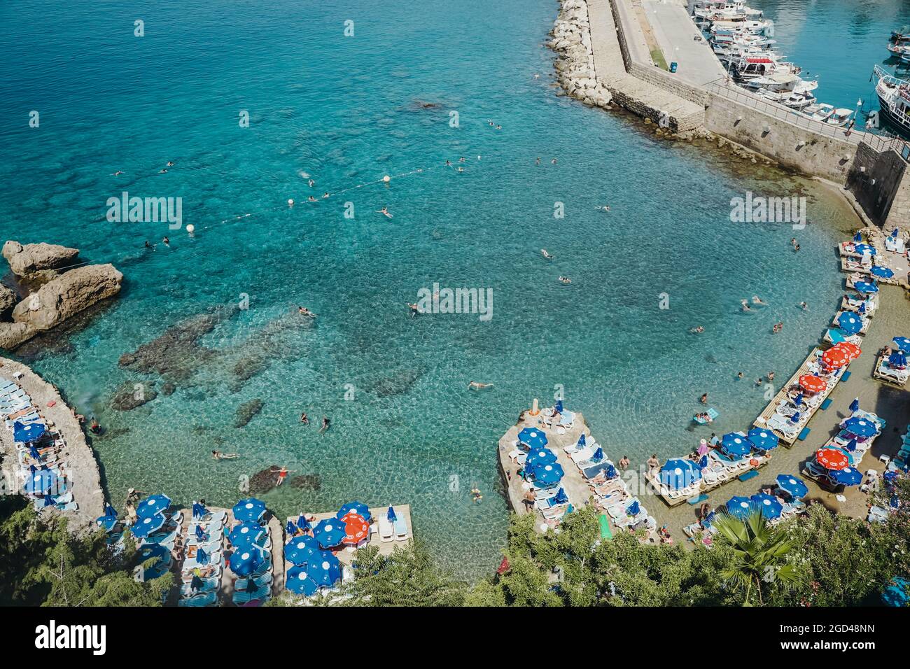 Antalya, Turkey - 30 July 2021: Mermerli beach in Antalya Turkey. Wonderful summer sunny turquoise beach on the Mediterranean coast. Rest, tourism and travel concept. . High quality photo Stock Photo