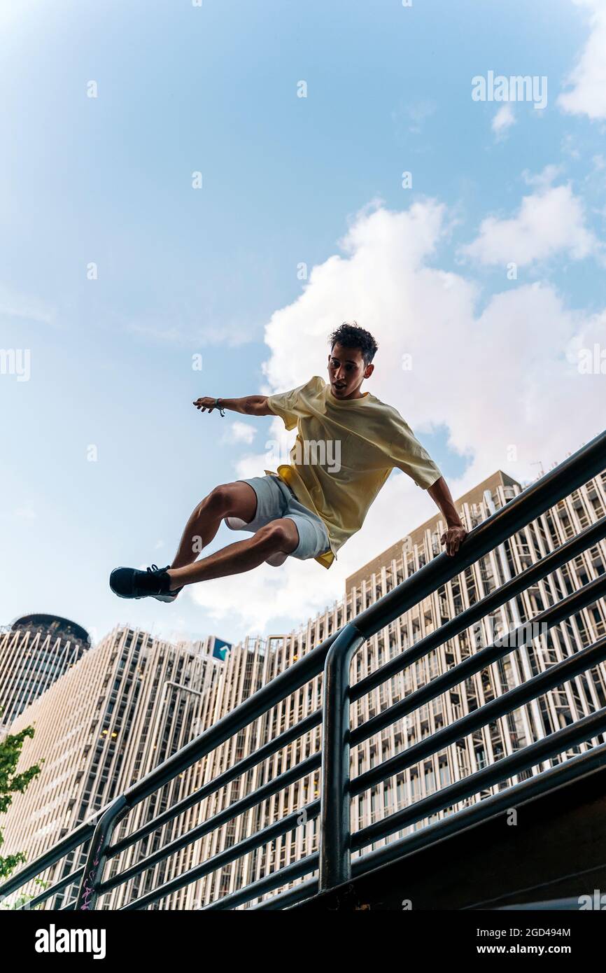 Concentrated cool man practicing parkour tricks in the city and having fun  Stock Photo - Alamy