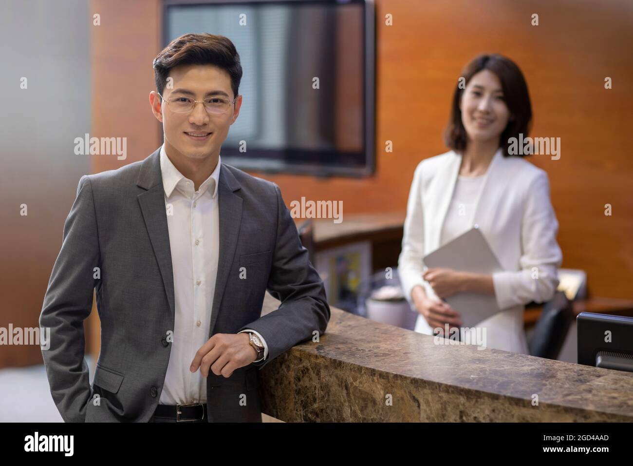 Businessman checking in at front desk Stock Photo