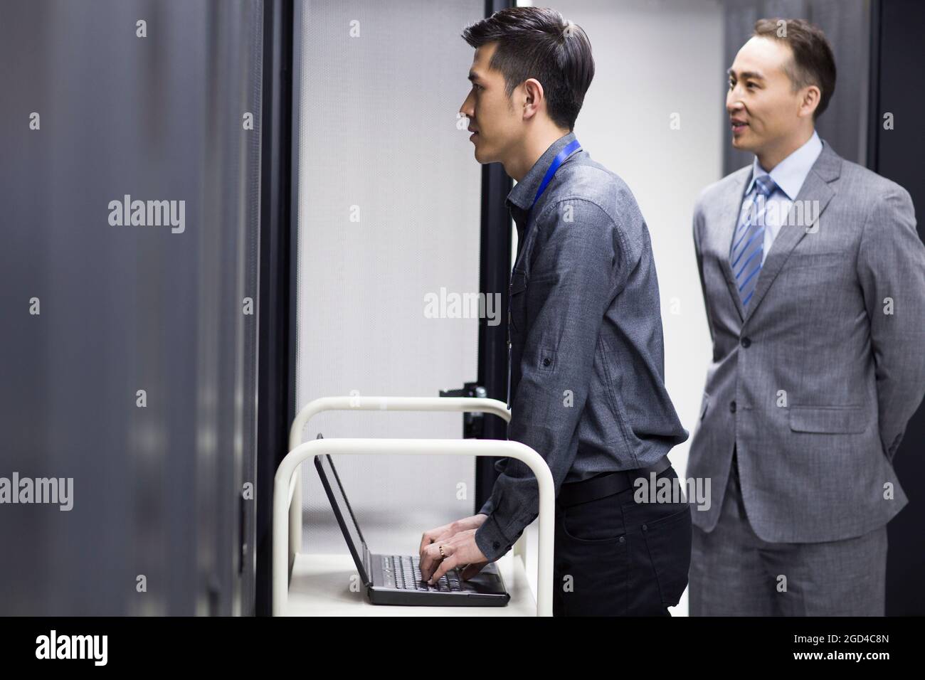 Technicians doing maintenance in computer room Stock Photo