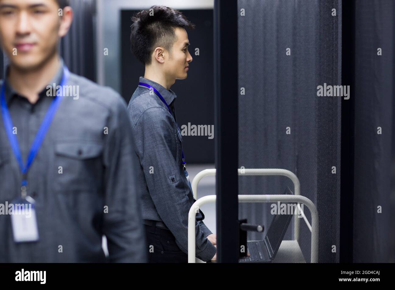 Businessman using laptop in computer room Stock Photo