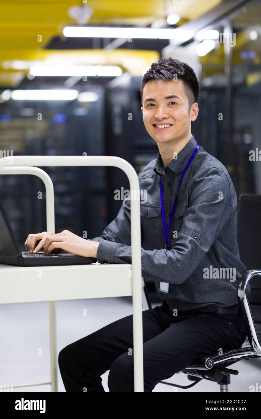 Businessman using laptop in computer room Stock Photo