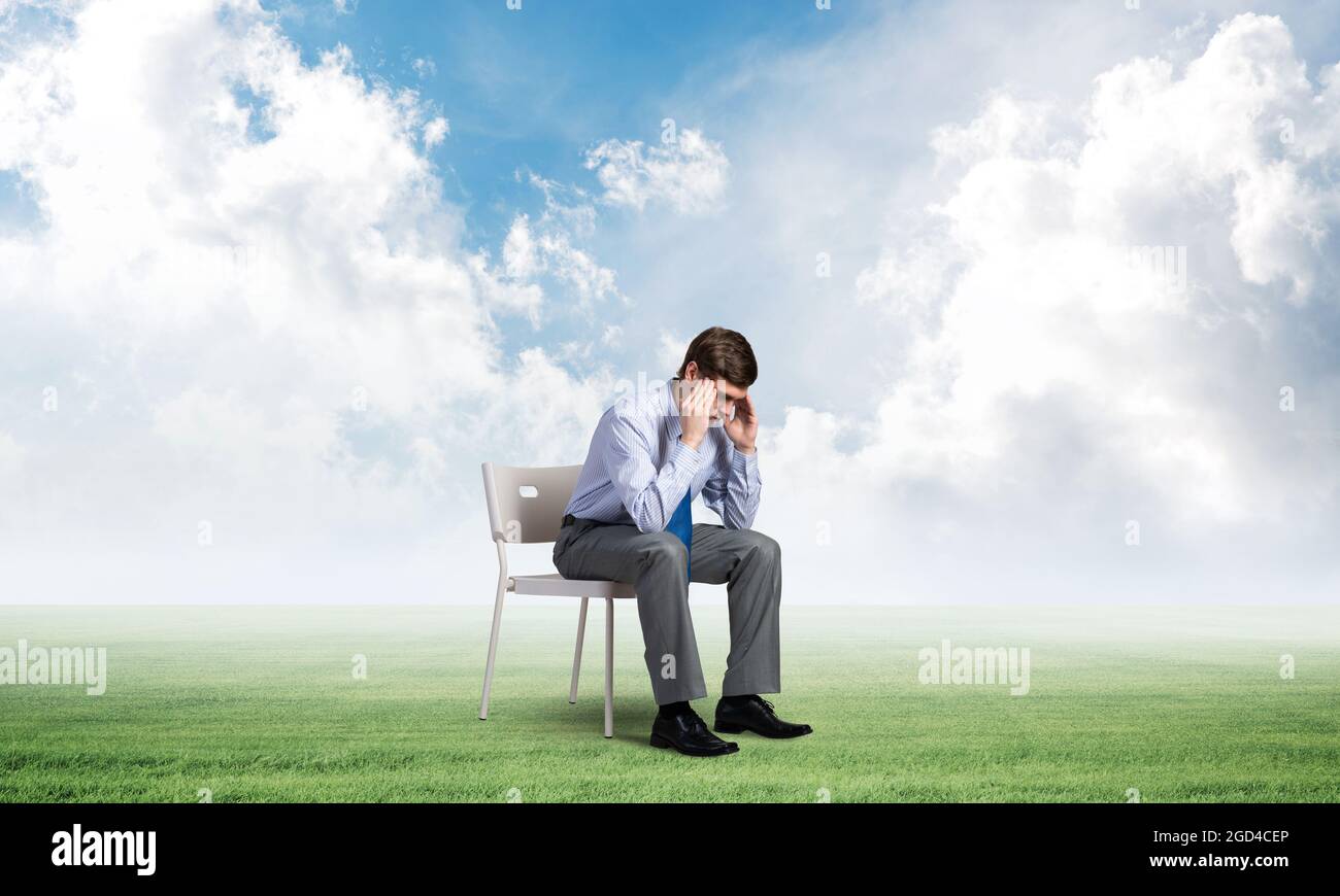 Businessman sitting on an office chair Stock Photo - Alamy