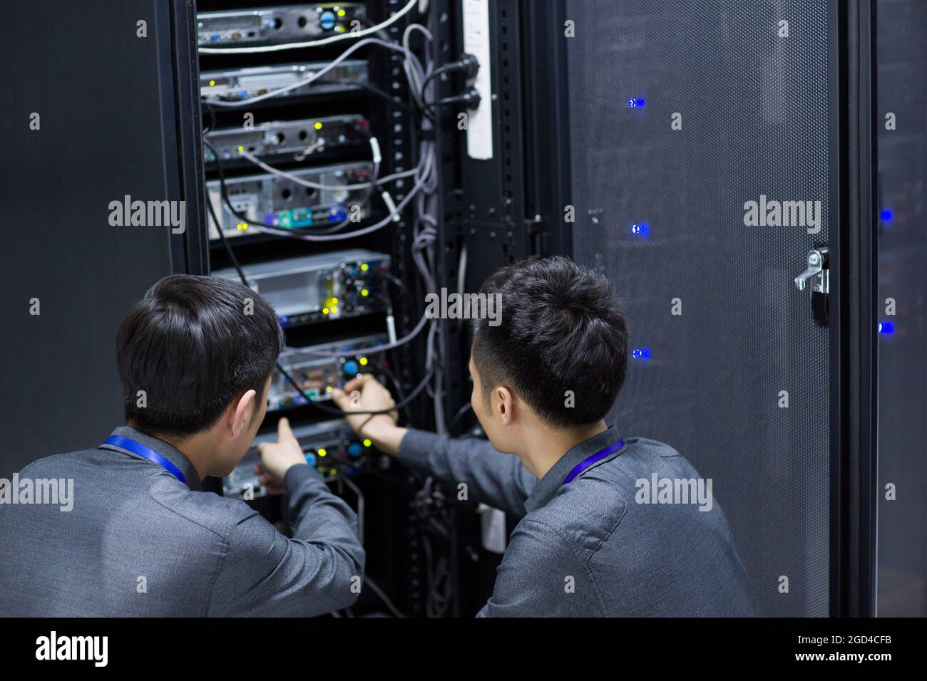 Technicians doing maintenance in computer room Stock Photo