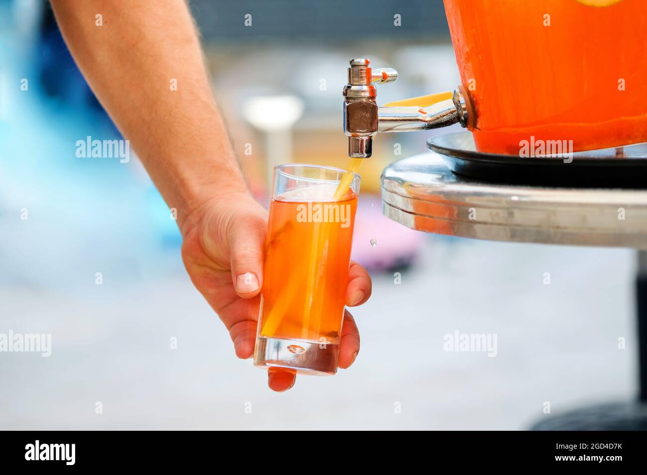 https://c8.alamy.com/comp/2GD4D7K/man-hand-pouring-fresh-sorbet-fruit-juice-or-alcohol-punch-from-drinking-tank-machine-at-party-2GD4D7K.jpg