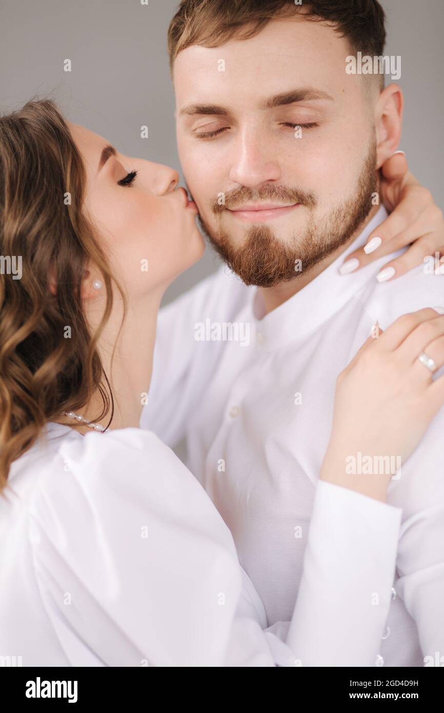Kiss cheek wedding day moment bride groom portrait love hi-res stock ...