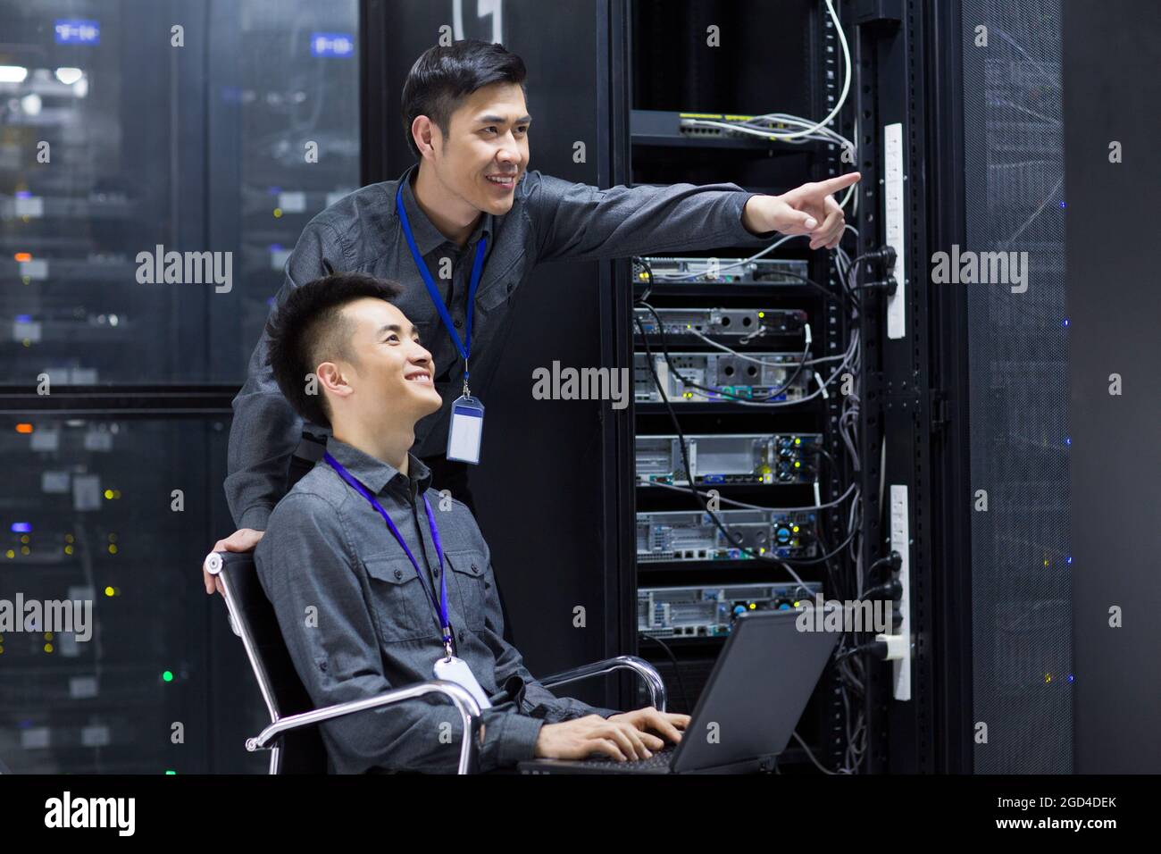 Technicians doing maintenance in computer room Stock Photo