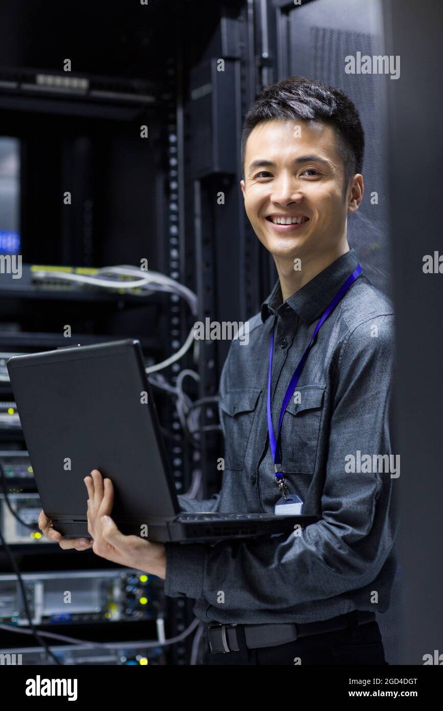 Technician doing maintenance in computer room Stock Photo