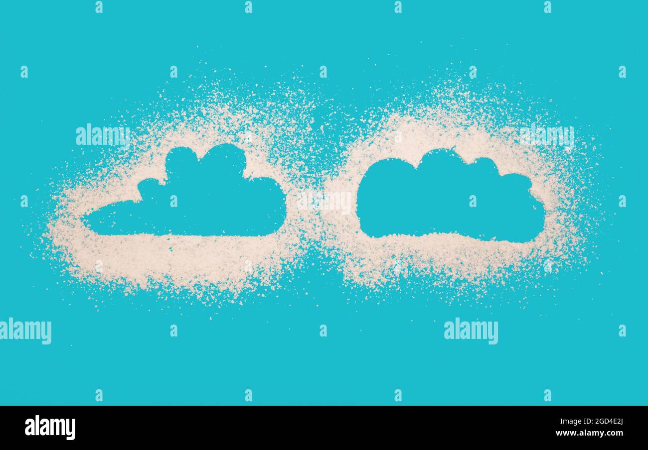 Outline of clouds on light blue background made by powdered suger as abstract concept for food or weather Stock Photo