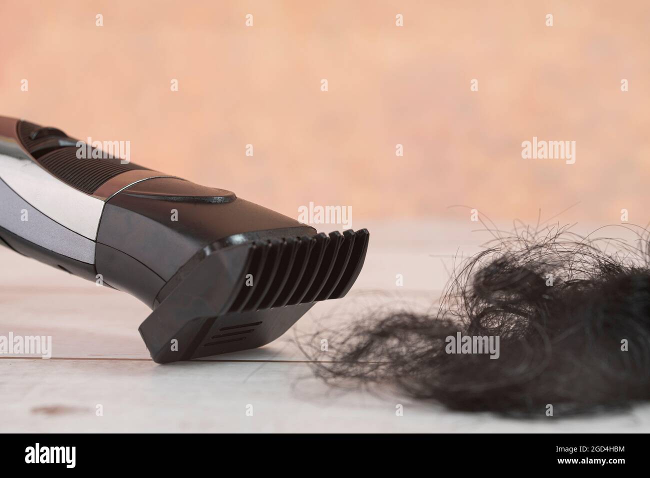 Cordless hair trimmer. During the pandemic when barbershops are closed, more men bought the devise to cut their own hair. Selective focus points. Blur Stock Photo