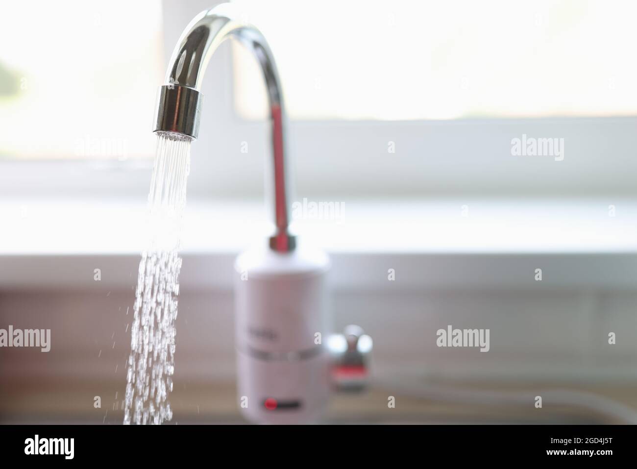 Pure water flows from faucet in kitchen closeup Stock Photo