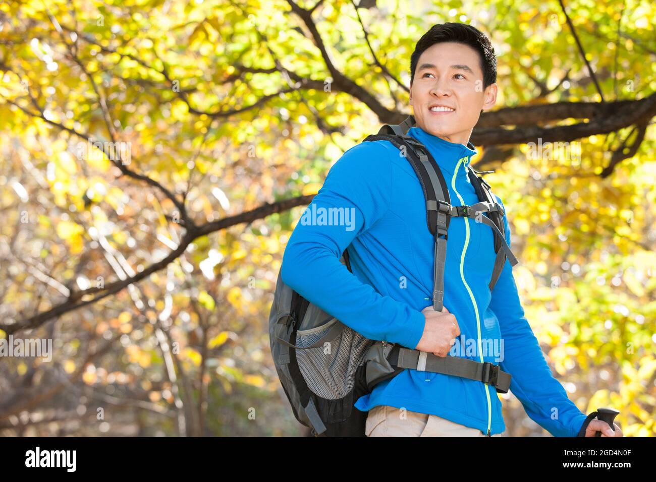 Happy male backpacker on a hike Stock Photo - Alamy