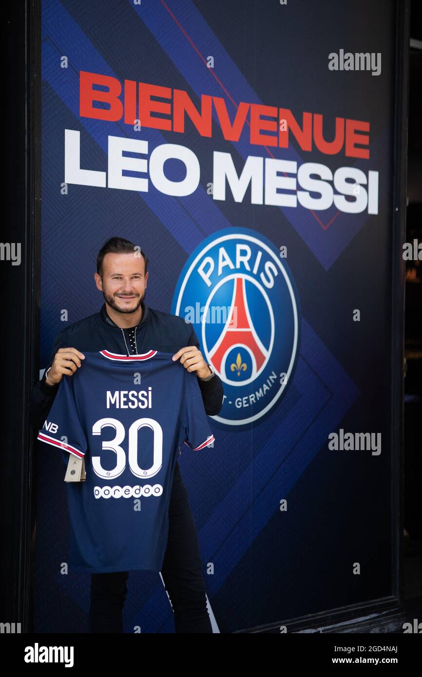 Paris, France. 11th Aug, 2021. A supporter shows a jersey of PSG's Argentinian football player Lionel Messi, that he has just bought at the Paris-Saint-Germain (PSG) football club store on the Champs Elysees avenue in Paris on August 11, 2021. Messi signed on August 10, 2021 a two-year deal with PSG with the option of an additional year. The 34-year-old will wear the number 30 in Paris, the number he had when he began his professional career at Barca. Photo by Raphael Lafargue/ABACAPRESS.COM Credit: Abaca Press/Alamy Live News Stock Photo