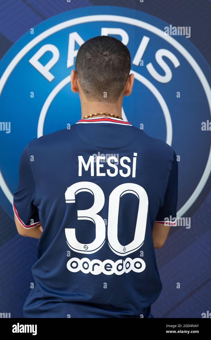 Paris, France. 11th Aug, 2021. A supporter shows a jersey of PSG's Argentinian football player Lionel Messi, that he has just bought at the Paris-Saint-Germain (PSG) football club store on the Champs Elysees avenue in Paris on August 11, 2021. Messi signed on August 10, 2021 a two-year deal with PSG with the option of an additional year. The 34-year-old will wear the number 30 in Paris, the number he had when he began his professional career at Barca. Photo by Raphael Lafargue/ABACAPRESS.COM Credit: Abaca Press/Alamy Live News Stock Photo