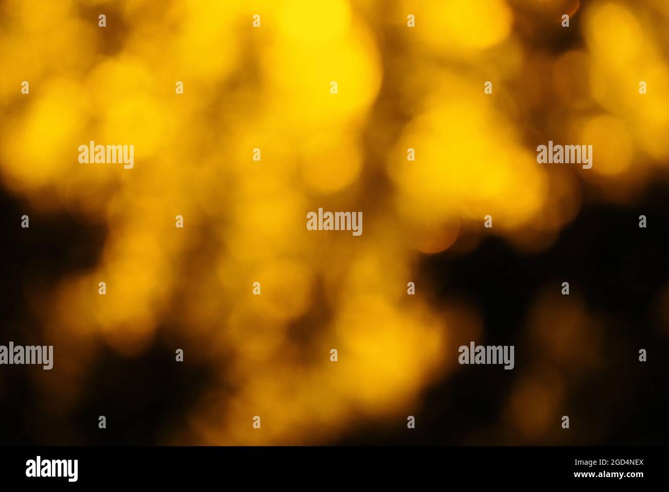 A background created by blurring yellow colored lights Stock Photo
