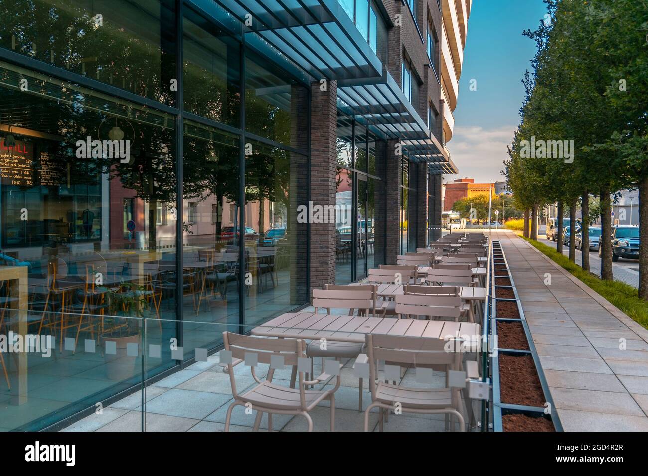 Empty street cafe. Empty tables and chairs of a street cafe. No visitors. Stock Photo