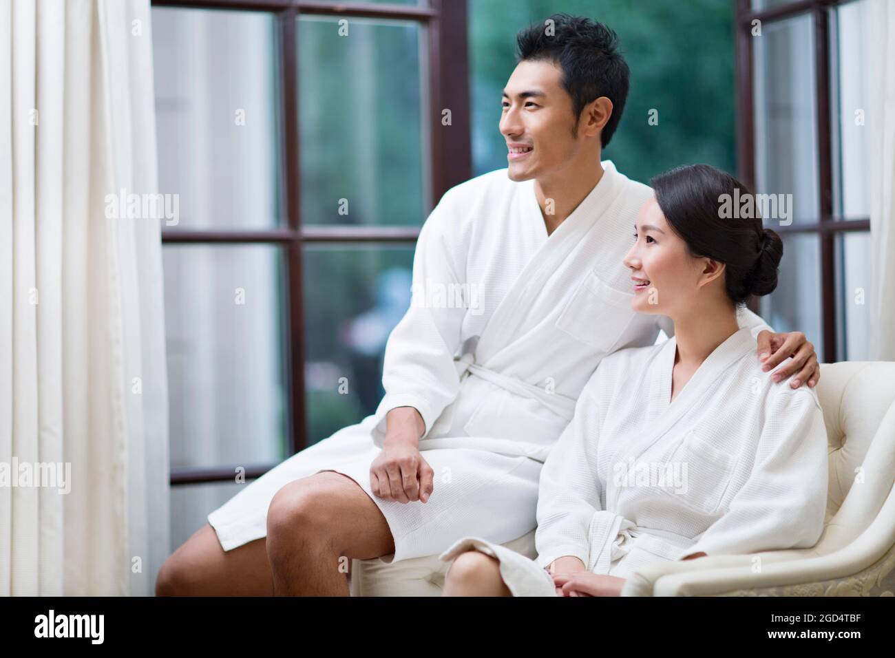 Young couple in bathrobes relaxing in a luxury hotel Stock Photo Alamy