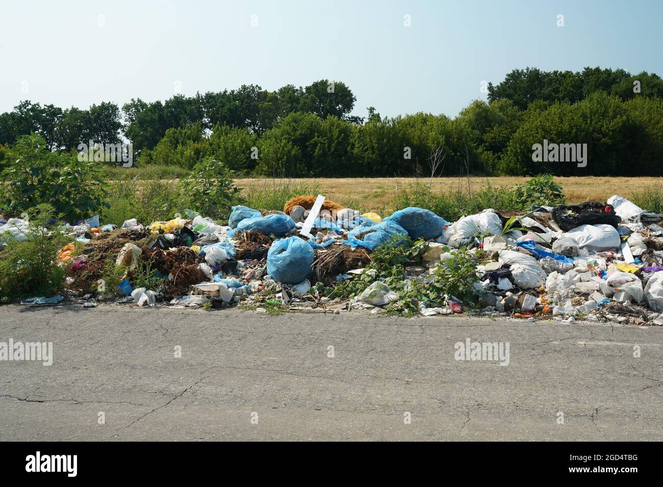 illegal rubbish dump near the road, garbage in the nature Stock Photo ...