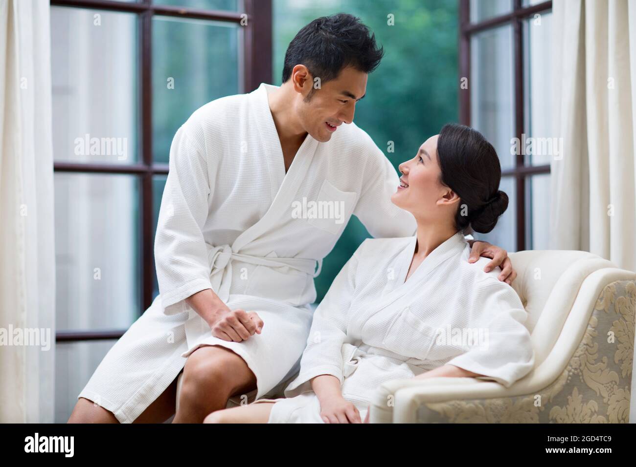 Young couple in bathrobes relaxing in a luxury hotel Stock Photo Alamy