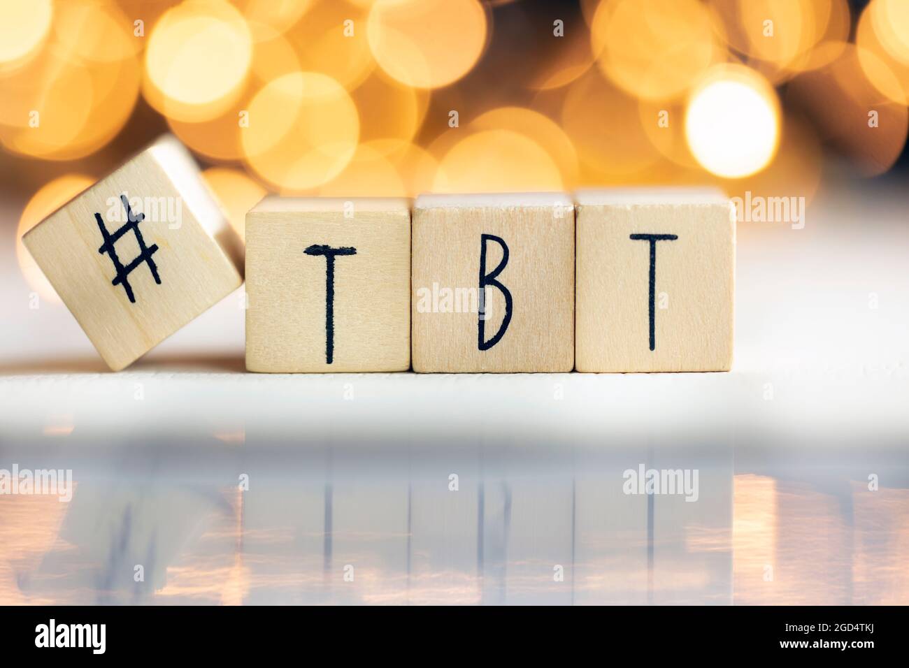 Hashtag TBT throwback Thursday written with wooden cubes with shiny bokeh background, social media concept Stock Photo