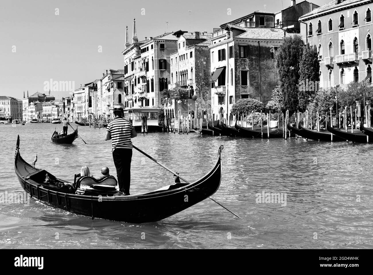 a gondolier in venice in the canal grande in summer 2020 in black and white Stock Photo