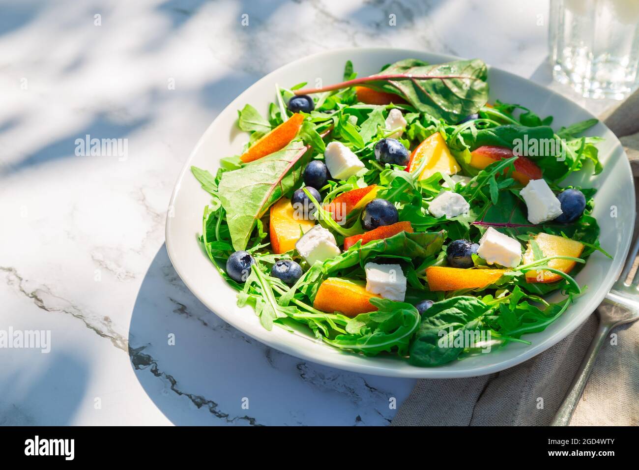 Fresh homemade salad with nectarines, blueberries, arugula, spinach and