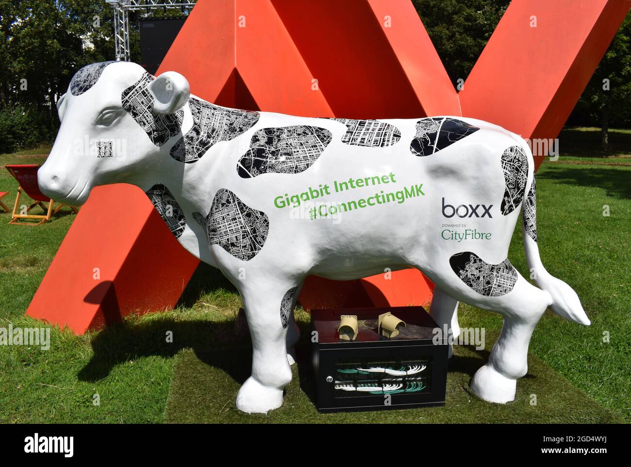 A high-tech concrete cow providing wi-fi access for an outdoor event in Fred Roche Gardens in Milton Keynes. Stock Photo