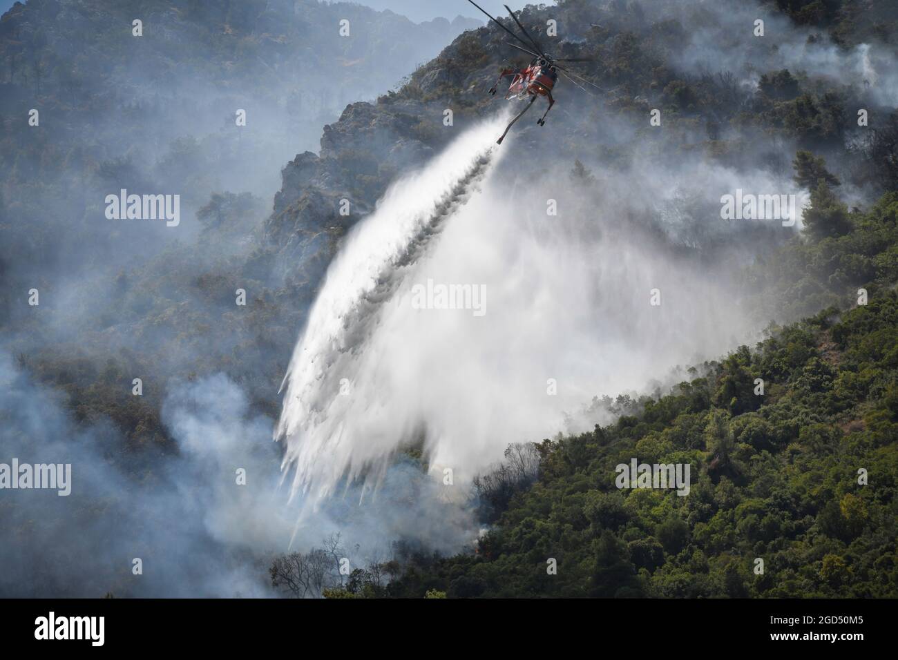 Greece - Attica region, fire damage the day after the devastating fire in the north of the Greek capital Athens. In the picture: Snapshot of after-fire work with helicopters near Malakasa Stock Photo