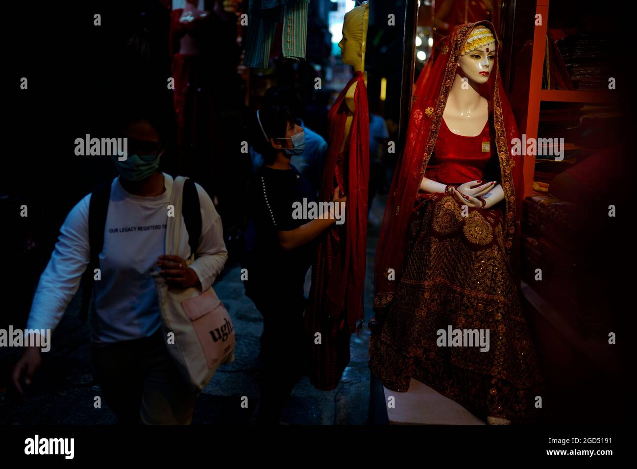 Kathmandu, Nepal. 11th Aug, 2021. A shopkeeper carries a mannequin