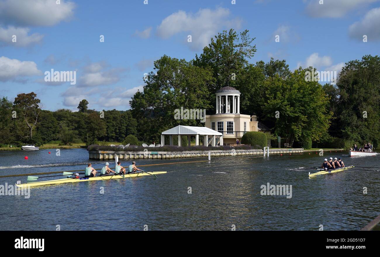 Cambridge University (left) and Isis Boat club compete in their Prince Albert cup race on the opening day of the 2021 Henley Royal Regatta alongside the river Thames. Picture date: Wednesday August 11, 2021. Stock Photo