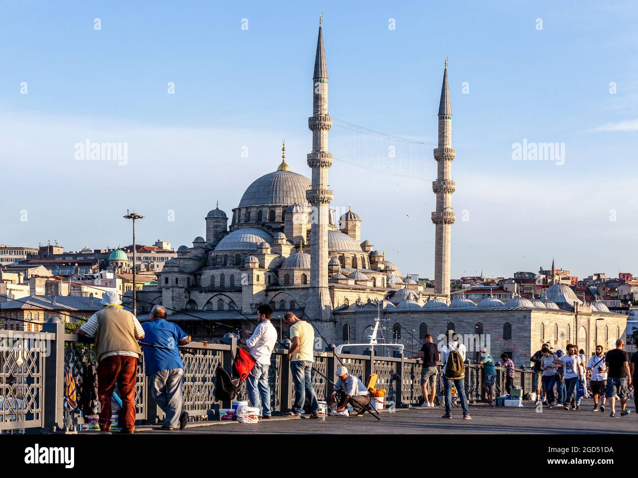 Istanbul / Turkey - 07.01.2015: New Mosque at the back side of the Fishermen on Galata Bridge. Eminonu, Istanbul, Turkey. Stock Photo