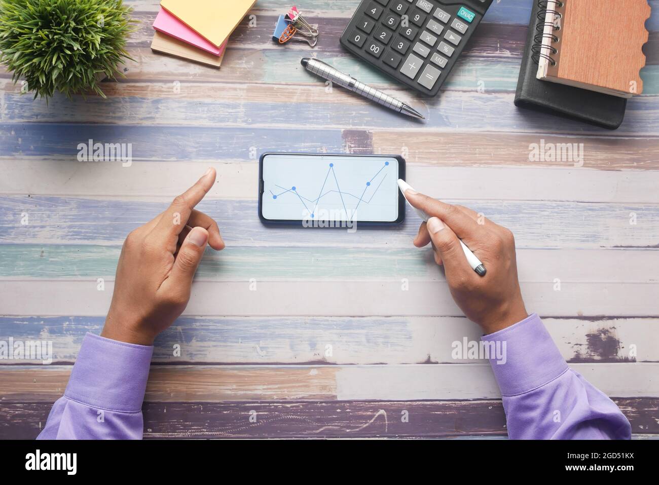young man analyzing stock chart on smart phone Stock Photo