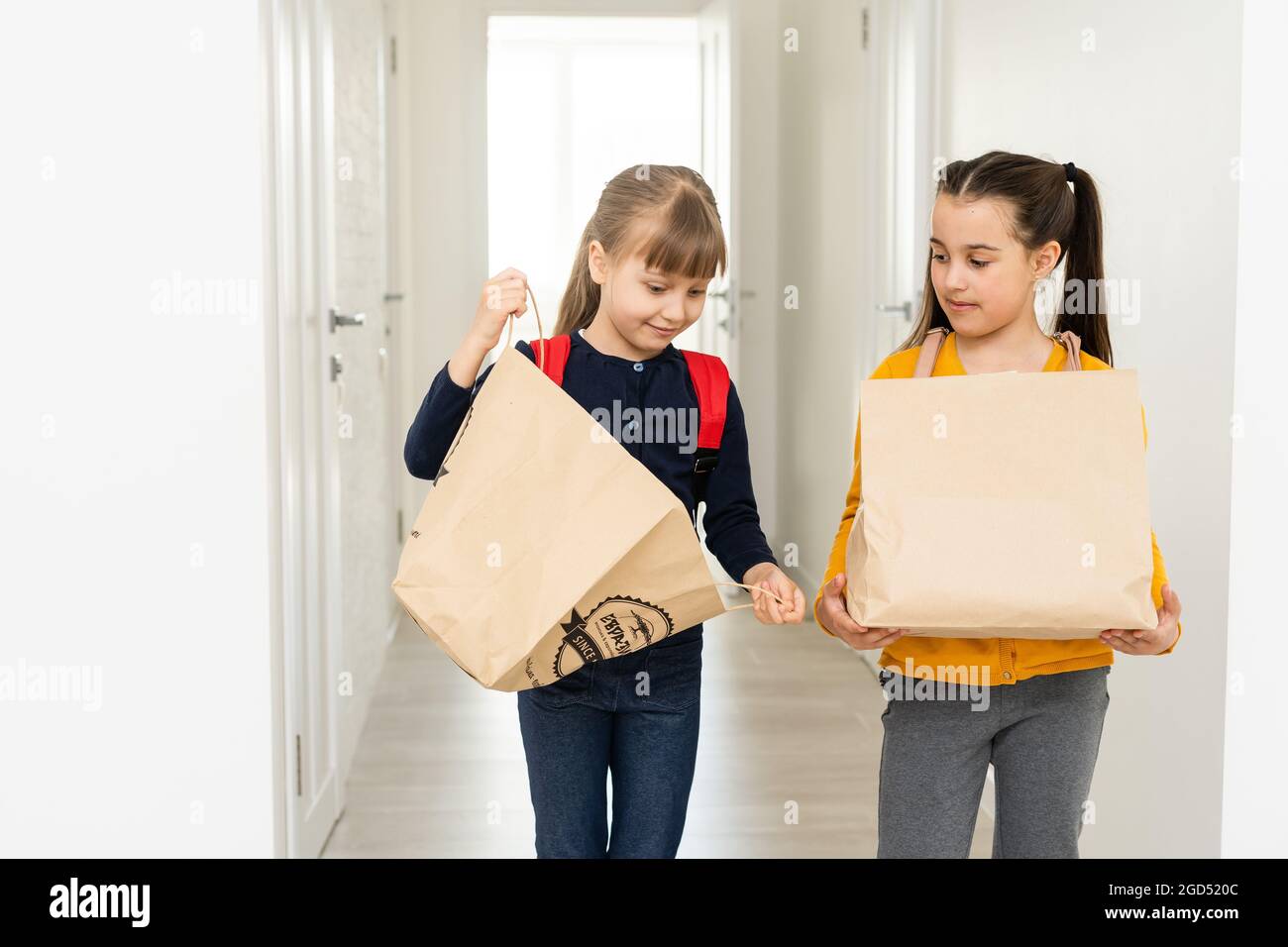 advertising, childhood, delivery, mail and people - two little girls with delivery packages Stock Photo