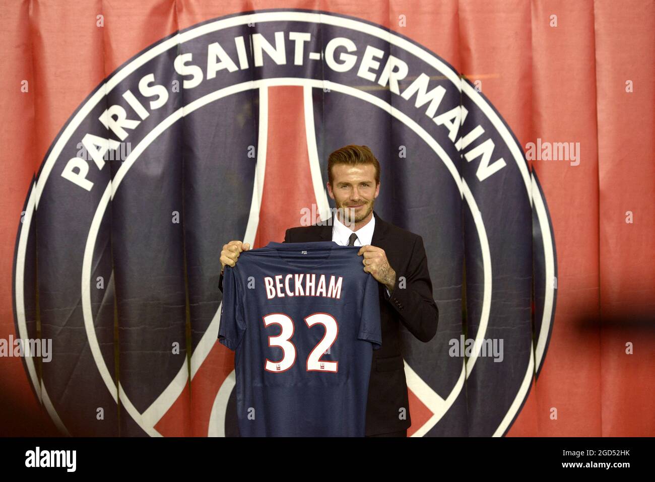 File photo dated January 31, 2013 of British and New PSG football player  David Beckham poses with his PSG Football shirt after his PSG signature at  the Parc des Princes stadium in