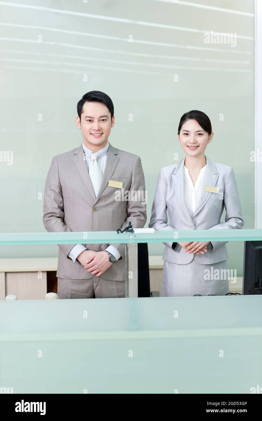Business persons at front desk Stock Photo Alamy