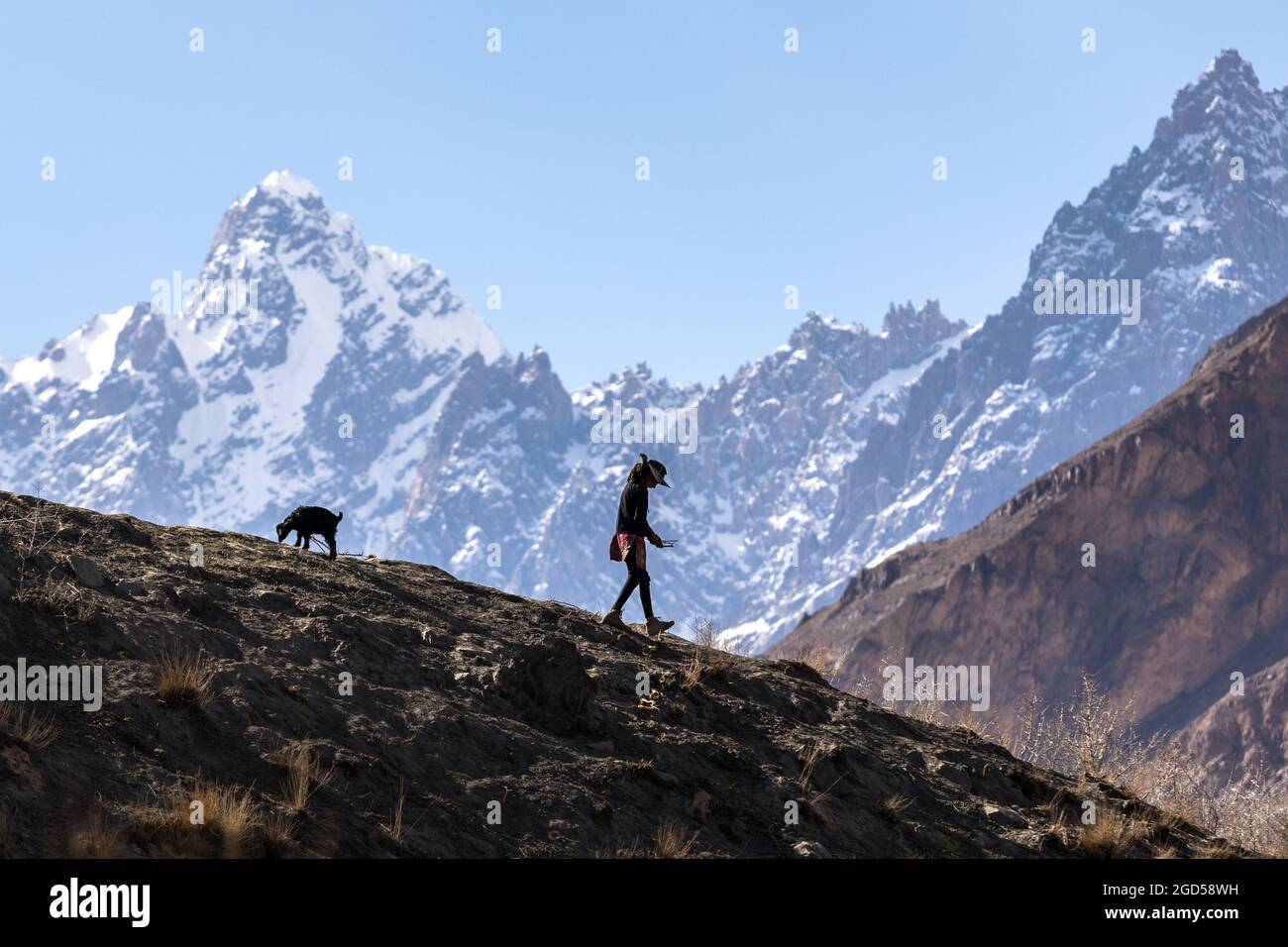 Hunza valley, Pakistan - June 2021:Silhouette girl walking in mountains  Stock Photo