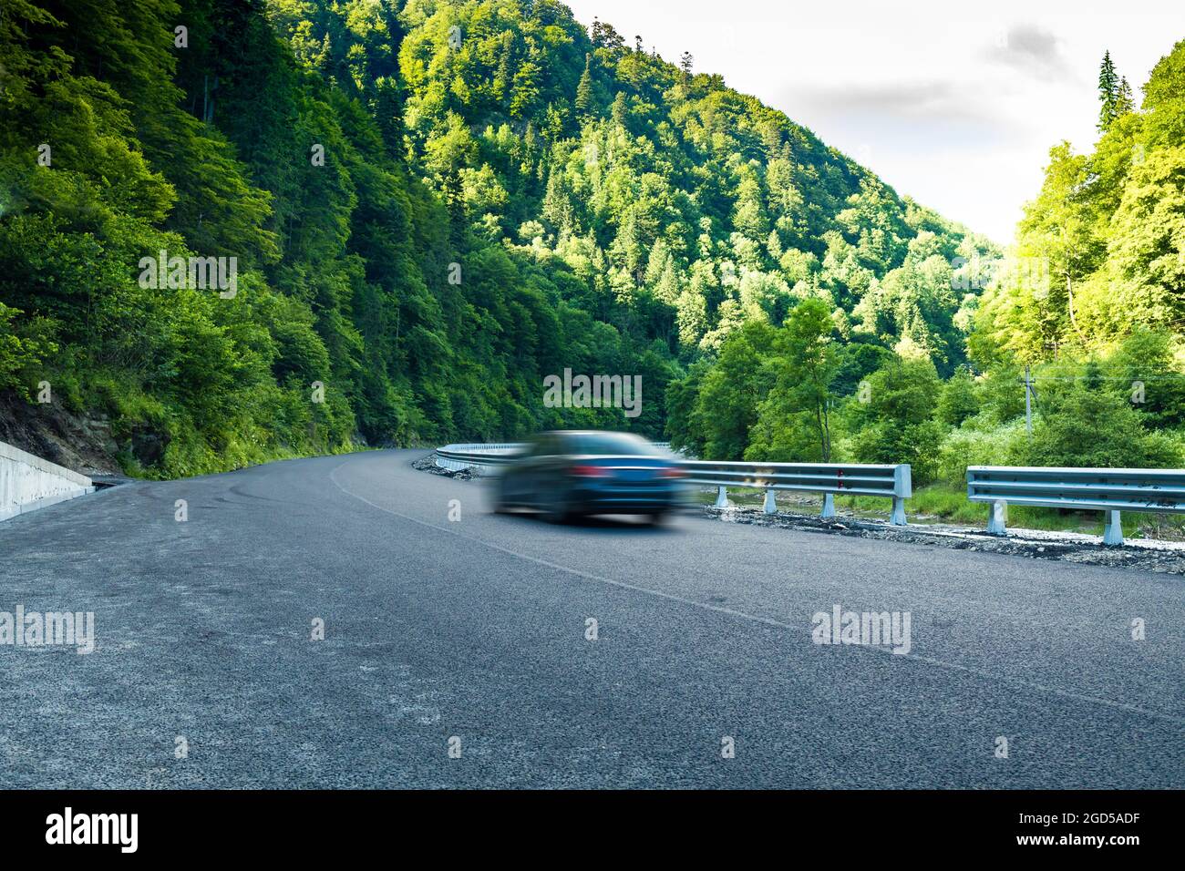 Rental car moving fast on the autobahn with beautiful nature autumn