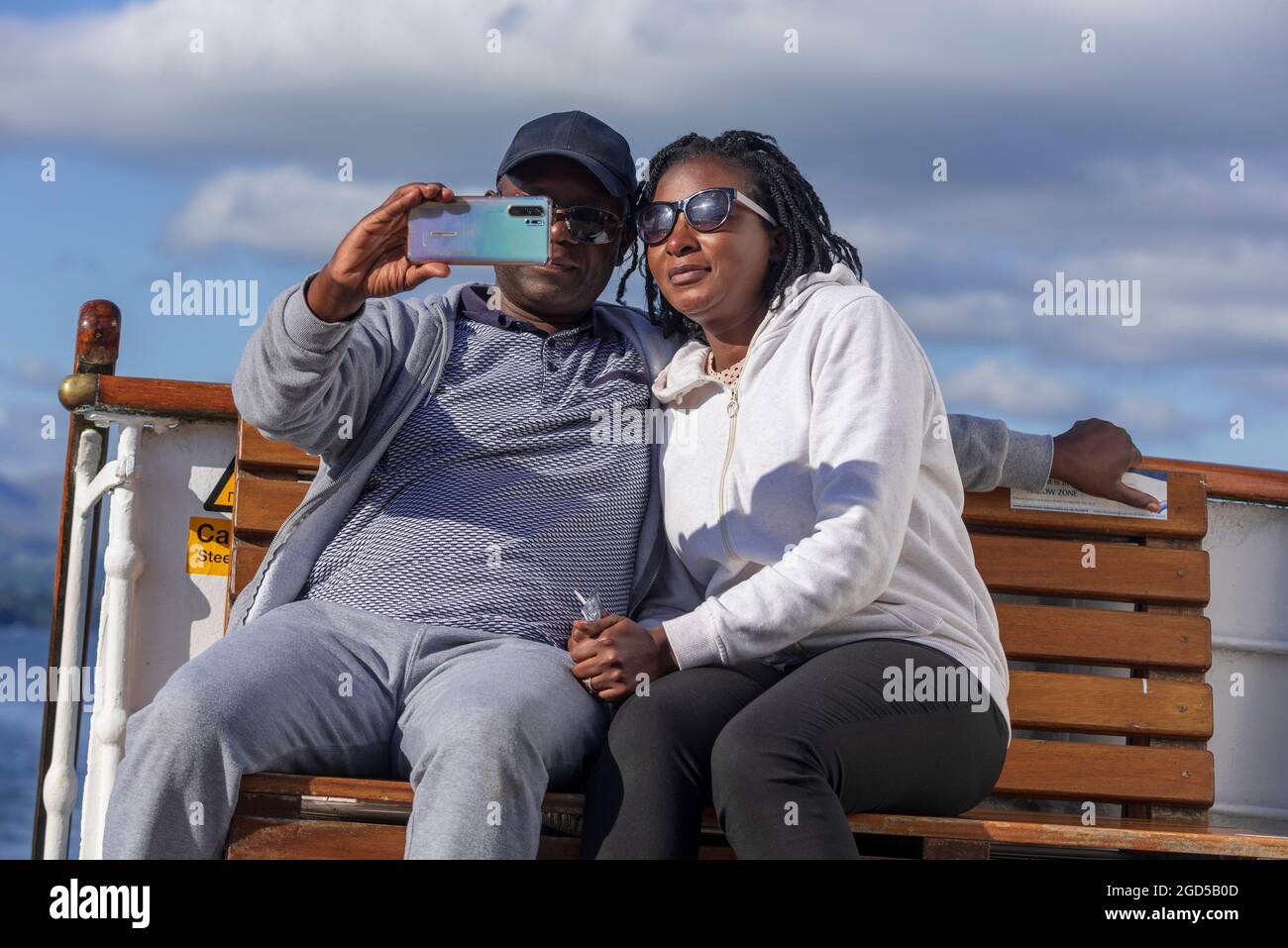 Happy couple taking selfie picture with a mobile phone camera. Stock Photo