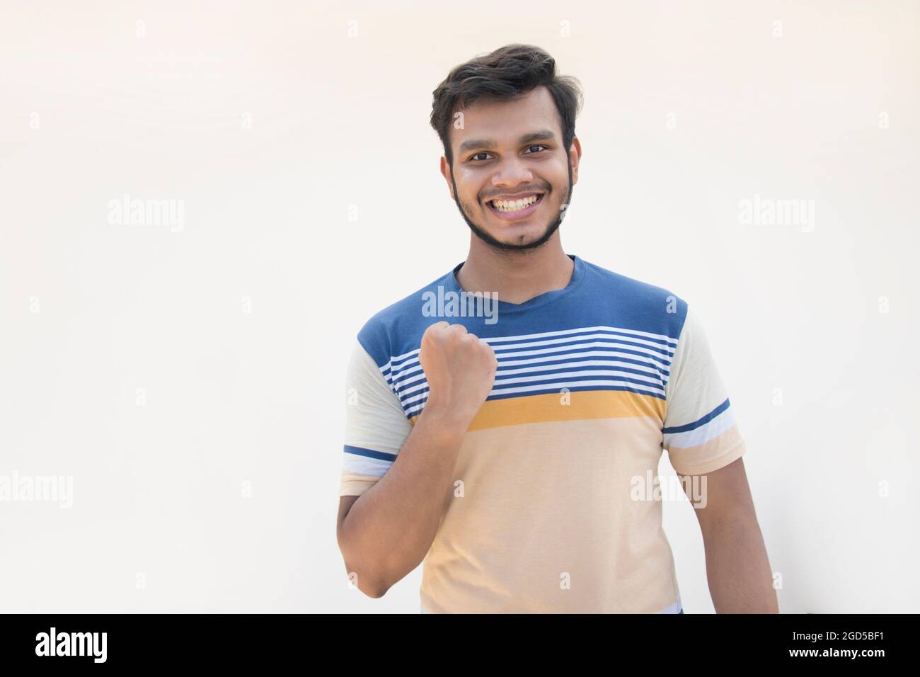 young man clenching fist in excitement and cheering Stock Photo Alamy