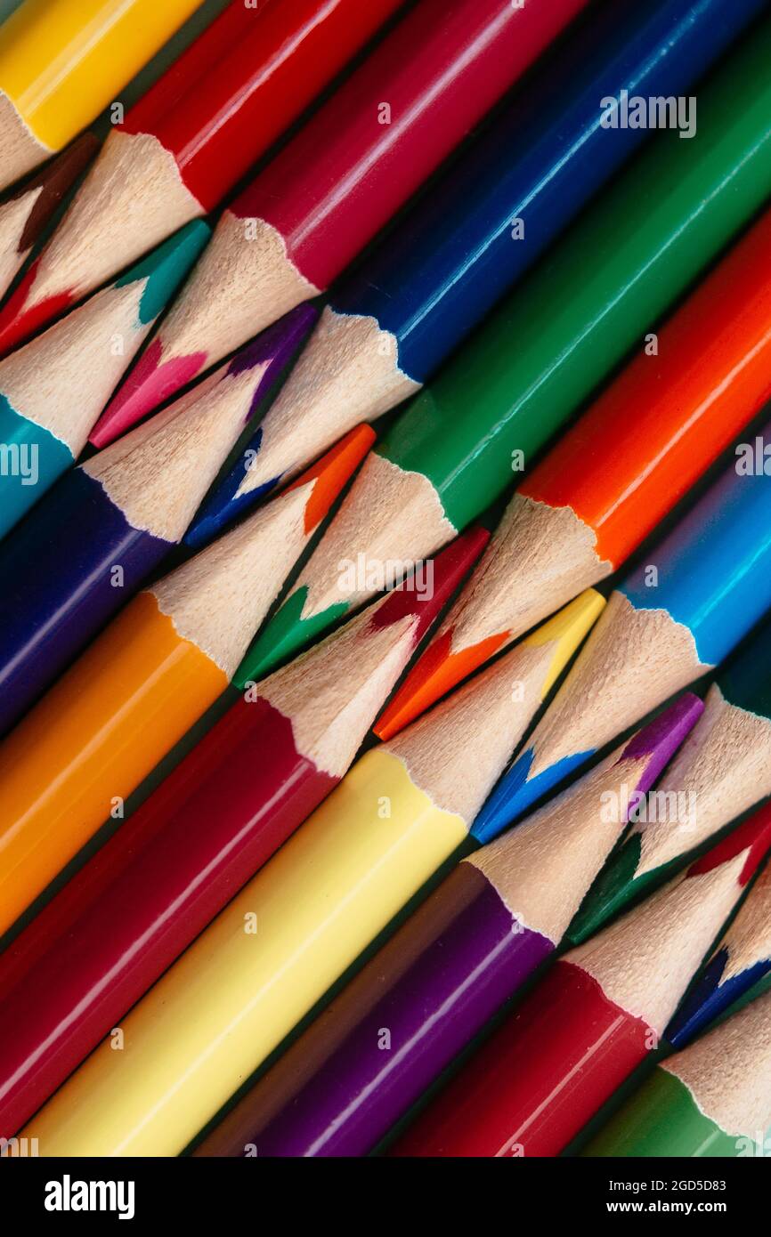 Colored sharpened pencils lie in a row close-up. Solid abstract ...