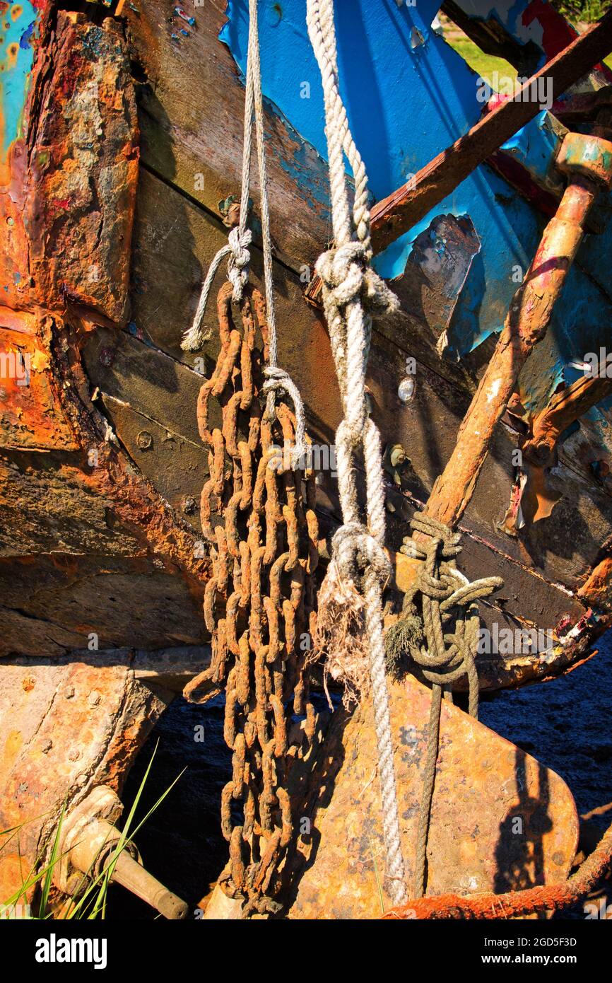 An abstract view of nautical decay. Chains and ropes hanging from a ...