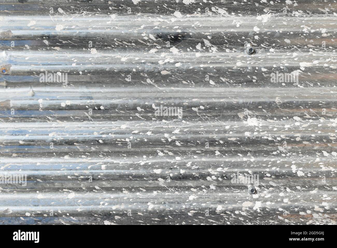 Corrugated sheet metal with plastering stains at construction site. Industrial background. Stock Photo