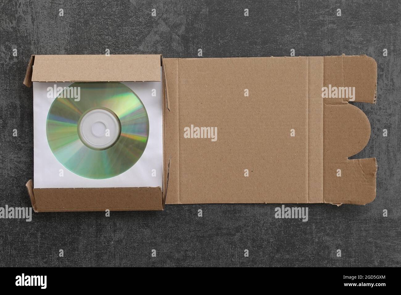 CD packed in cardboard mailer shipping box. Stock Photo