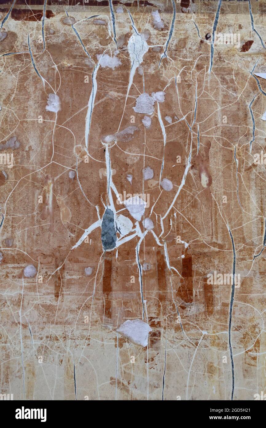 Cracked plastic surface with torn paper and adhesive tape stains. Abstract background. Stock Photo